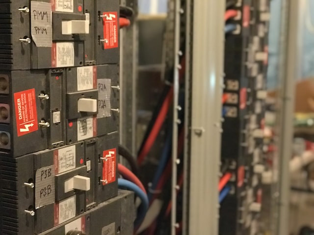 circuit panel close up with red, blue and black cables